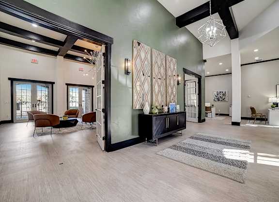 Clubhouse entry with green accent wall, console table, and open sightlines to lounge.