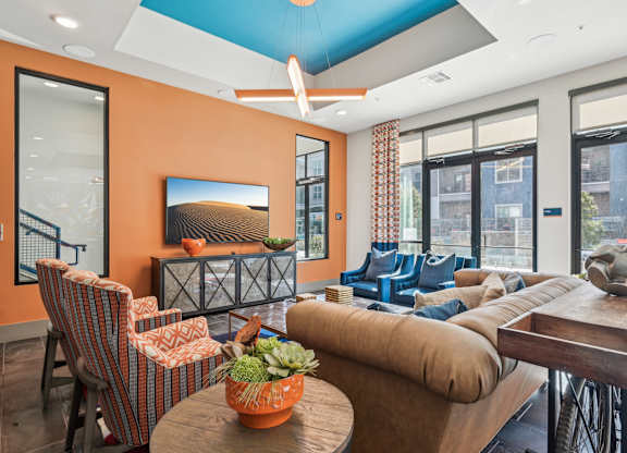 A living room with orange walls and furniture.