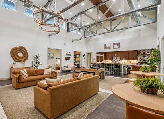 A living room with a brown couch and a wooden table.