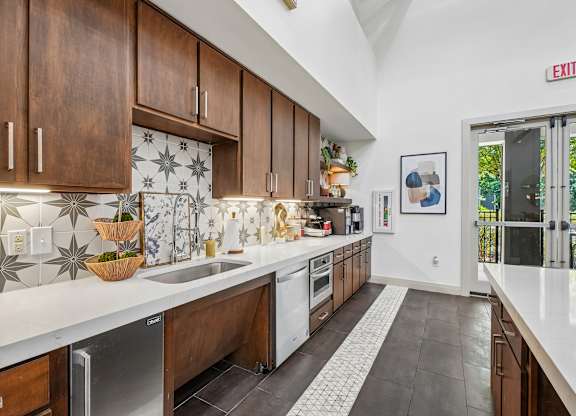 A kitchen with a white counter top and brown cabinets.