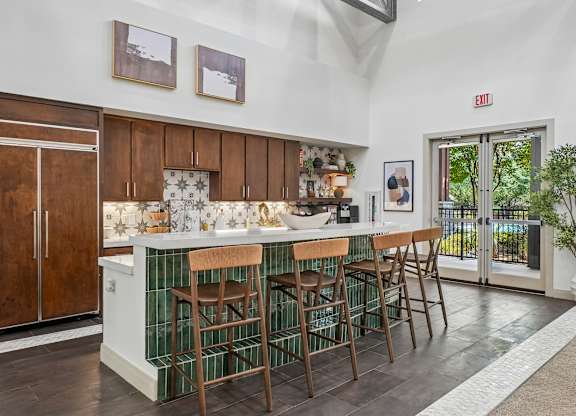 A kitchen with a bar area and a potted plant.