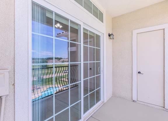 A white door is closed with a glass window above it.