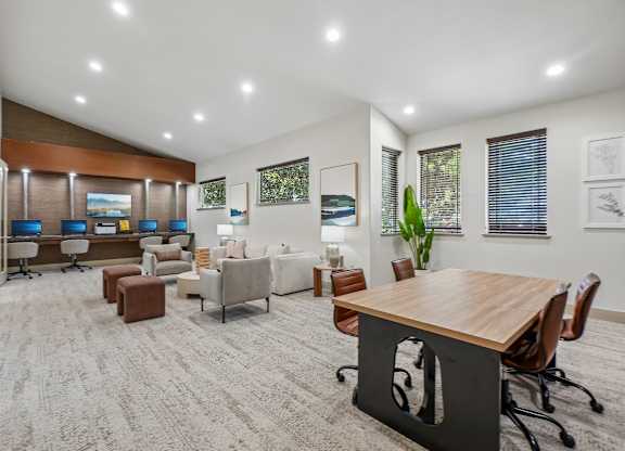 A modern office space with a variety of seating options and a long wooden table.