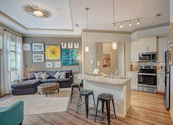 an open living room and kitchen with a bar and a counter top