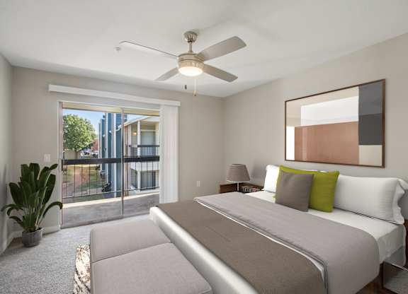 A bedroom with a large bed and a ceiling fan.