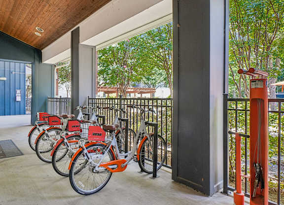 A row of bicycles are parked in a row.