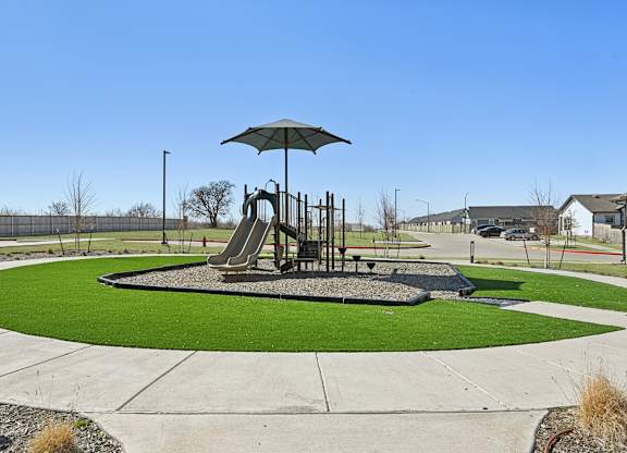 A playground with a slide and a swing set.