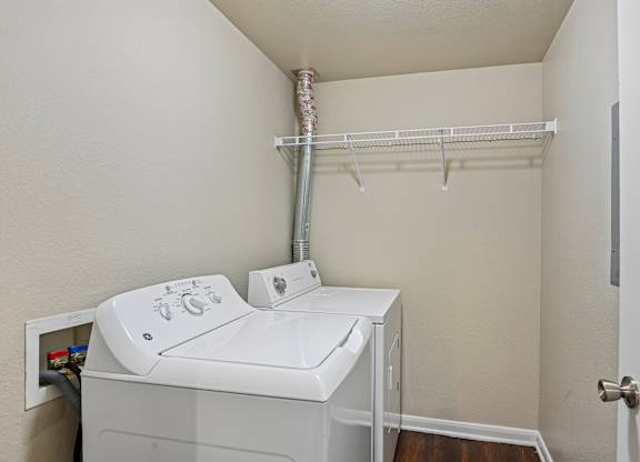 A small laundry room with a washer and dryer.