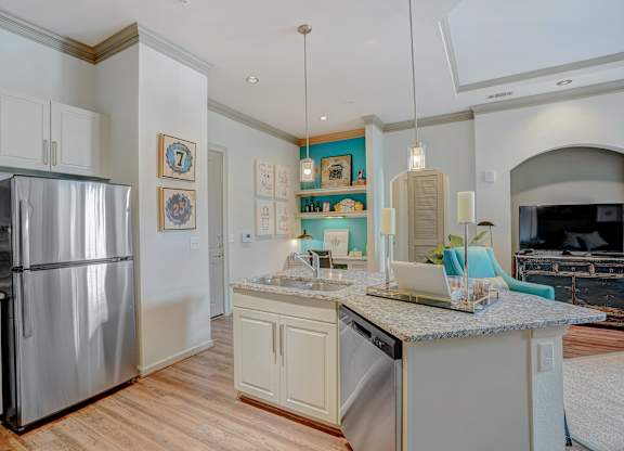 a kitchen with stainless steel appliances and a granite counter top