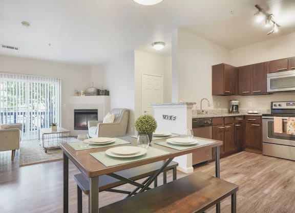 a living room with a dining room table and a kitchen