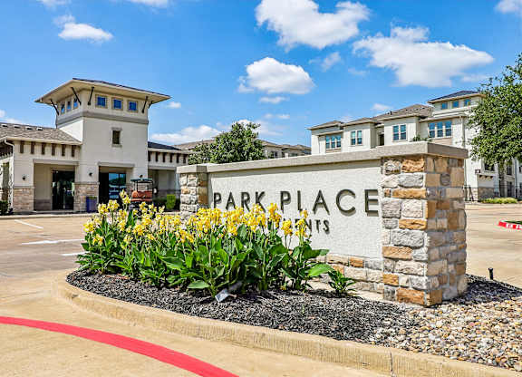 A sign that says Park Place in front of a building.