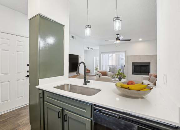 A kitchen with a bowl of fruit on the counter.