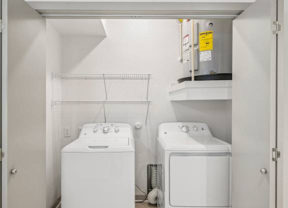 A small laundry room with a washer and dryer.