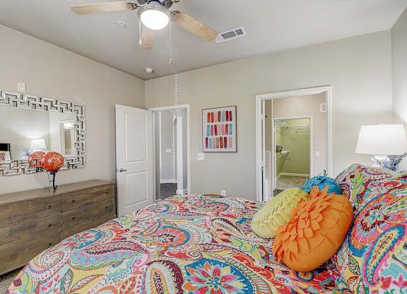 a bedroom with a bed and a ceiling fan