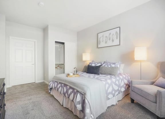 a bedroom with a bed and a chair
