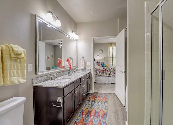 a bathroom with a shower and a sink and a mirror