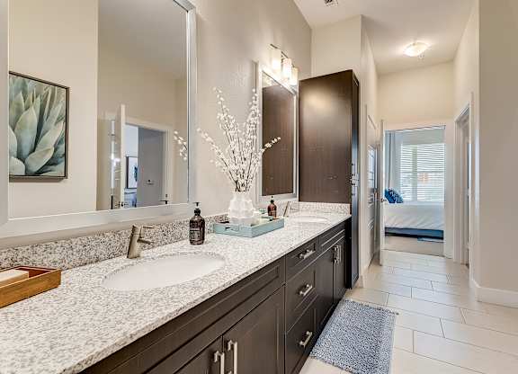 A bathroom with a large mirror above a double sink vanity.