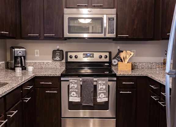 a kitchen with stainless steel appliances and granite counter tops