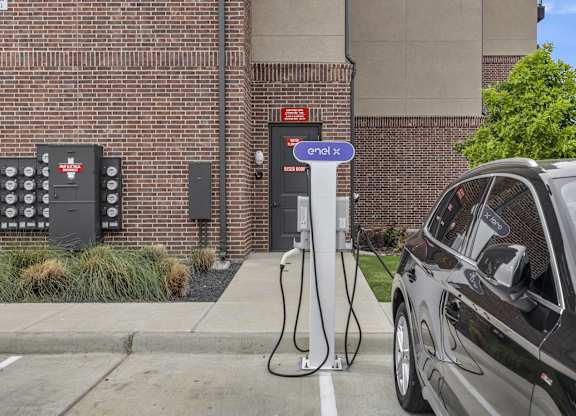 a car plugged in to a electric charger at a charging station