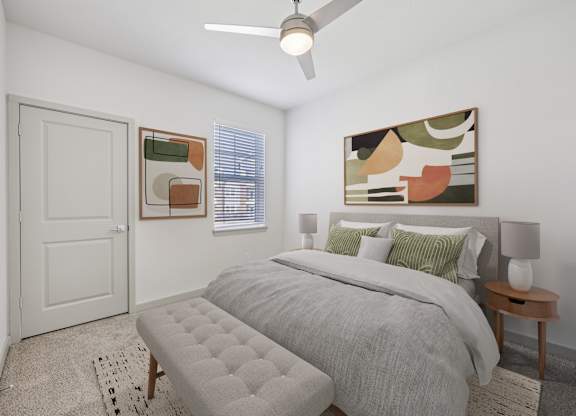 A bedroom with a bed, a bench, and a painting on the wall.