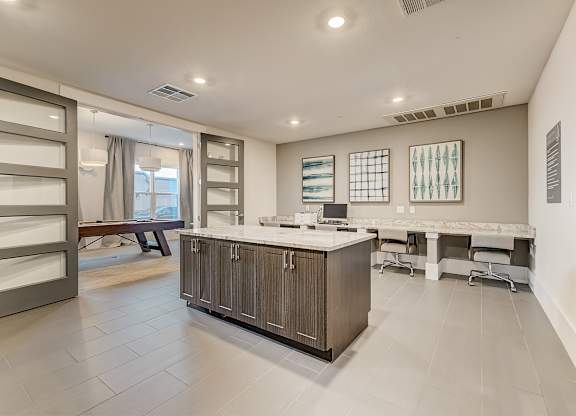 A spacious kitchen with a marble countertop and a large island.