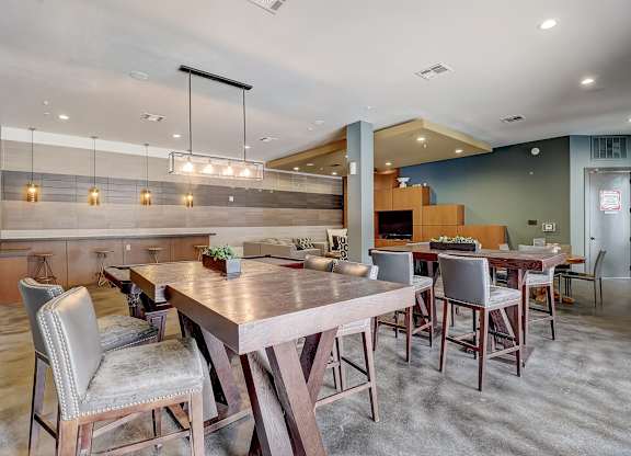 a large dining room with tables and chairs and a kitchen