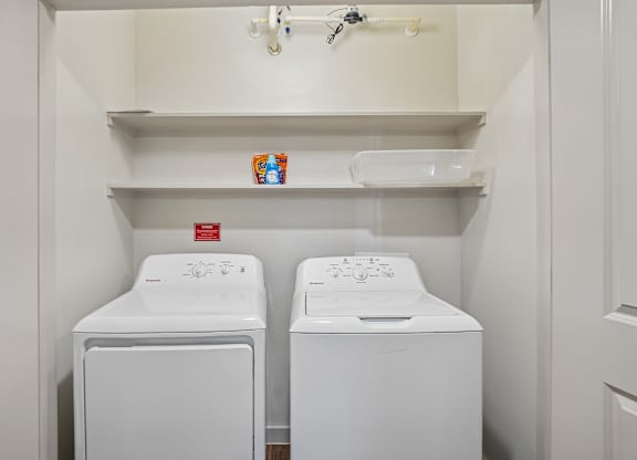 A small laundry room with two washing machines.