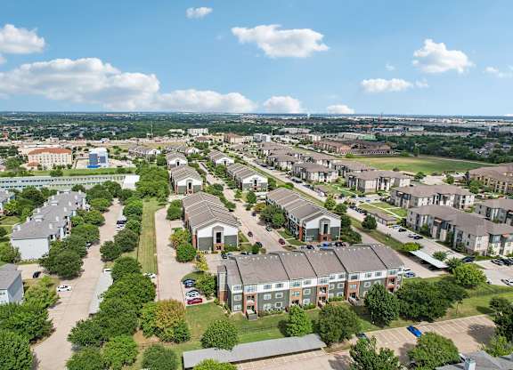 A bird's eye view of a residential area with houses and trees.