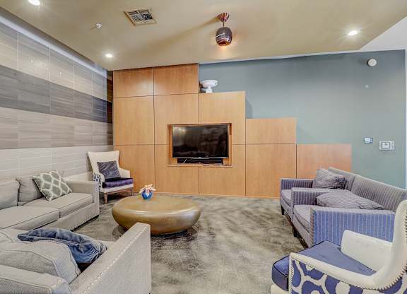 a living room with couches and chairs and a television