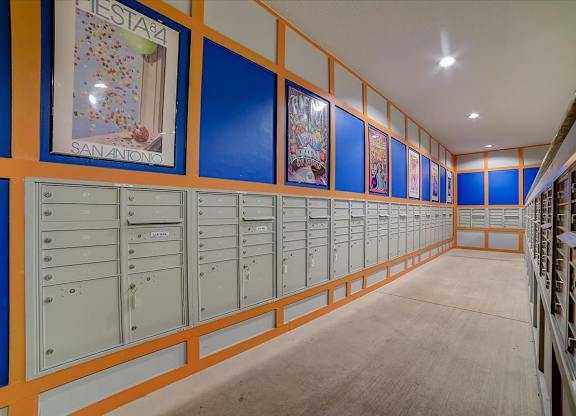 A long hallway with mailboxes on the wall.