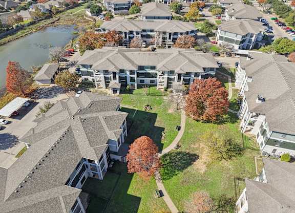 A bird's eye view of a residential area with houses and a river.