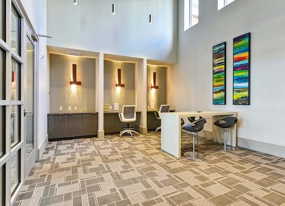 A modern office space with a reception desk and chairs.