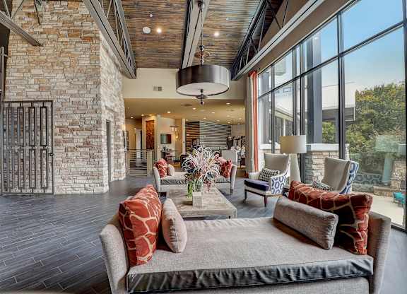 a living room with furniture and large windows
