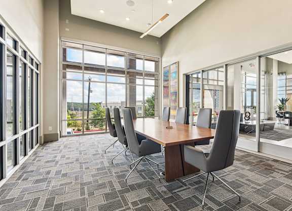 A conference room with a long table and chairs.
