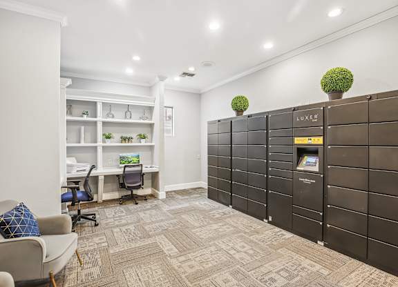 A room with a couch, chairs, and a desk with a computer on it.