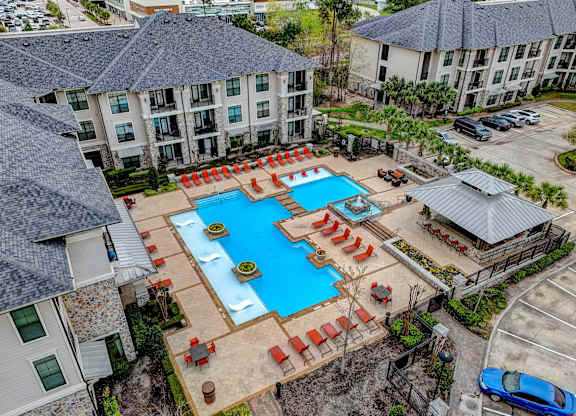 an aerial view of an apartment complex with a large swimming pool