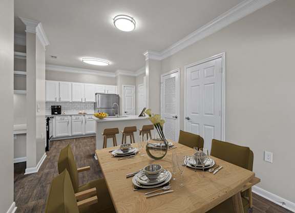 a dining room and kitchen with a wooden table and chairs