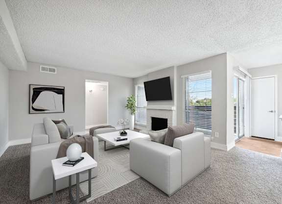 a living room with white furniture and a fireplace