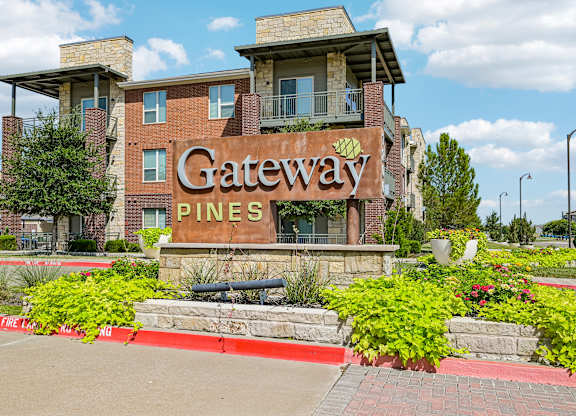 The image shows a building with a sign that reads "Gateway Pines".