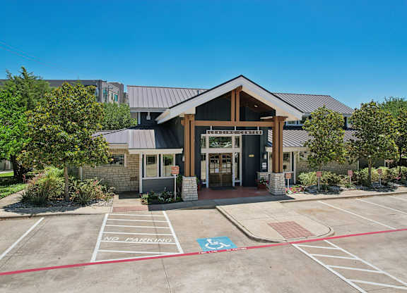 A building with a parking lot in front of it.