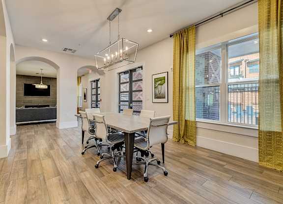 A conference room with a long table and chairs.