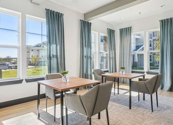 A dining room with a table and chairs.