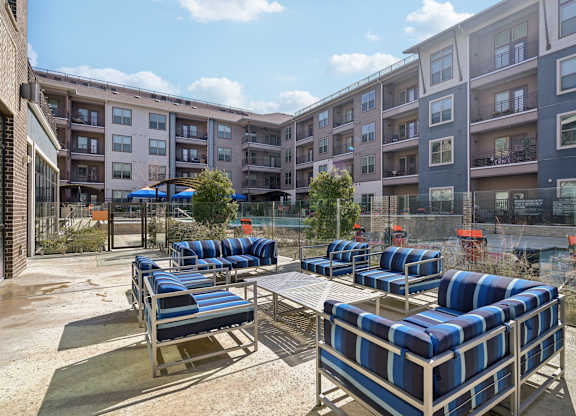 A sunny day at the outdoor seating area of a modern apartment complex.
