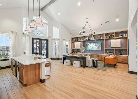 A kitchen with wooden floors and a large island.