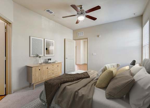 a bedroom with a large bed and a ceiling fan