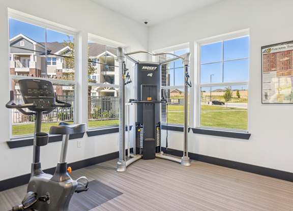 A home gym with a treadmill, a stationary bike and a weight machine.