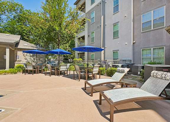 A sunny day at the outdoor seating area of a building.