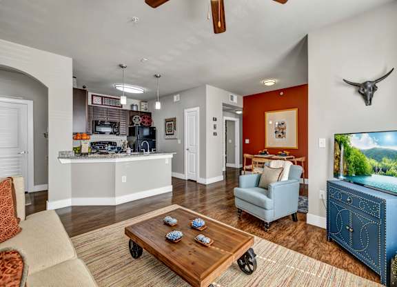 A living room with a blue couch and a wooden coffee table.
