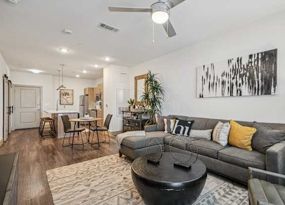 A modern living room with a grey couch and a coffee table.