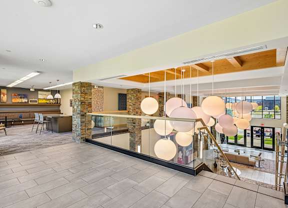 A modern interior space with a stone wall and a glass barrier.